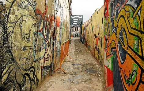 Una calle empedrada del Albaicn decorada con grafitis. | Jess G. Hinchado