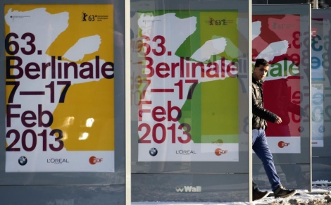 Un joven transita entre varios carteles del festival de cine de Berln. | Reuters