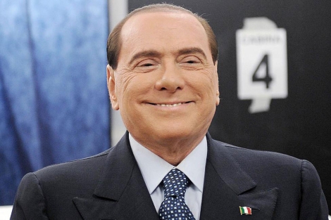 Berlusconi sonríe momentos antes de depositar su voto. | Efe