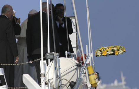 Momento en que el Papa arroja la corona de flores al mar. | Efe