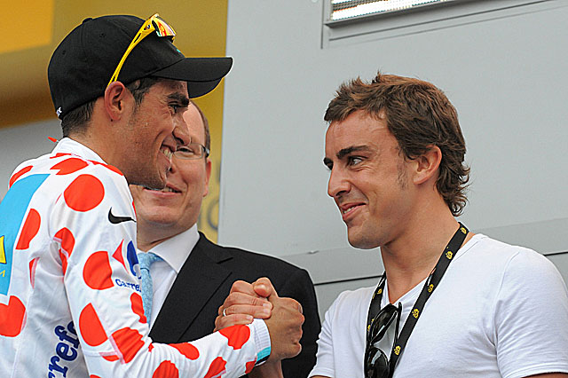 Fernando Alonso, gran aficionado al ciclismo, saluda a Contador en una edicin del Tour. | AFP