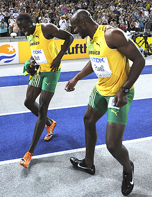 Bolt y Powell, tras la final de 100, en la que fueron oro y bronce respectivamente, (Foto: AFP)