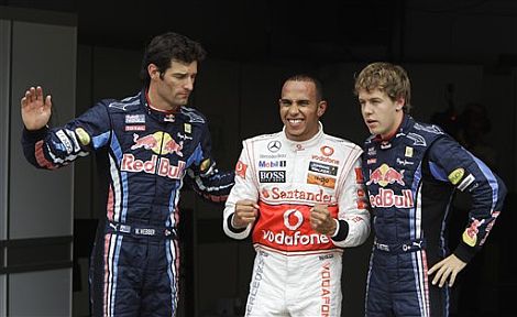 Lewis Hamilton, escoltado por Mark Webber (izda) y Sebastian Vettel (dcha). | Ap