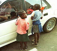 Nios de la calle pidiendo a un conductor en Harare, capital de Zimbabue (Rob Cooper | AP)