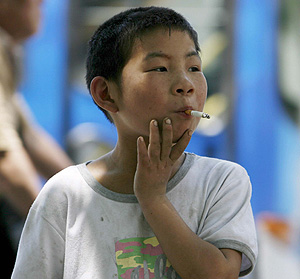 Un nio de siete aos fuma un cigarrillo en una calle de Pekn, China (Foto:EFE | Diego Azubel)