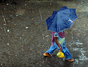 Una mujer india camina bajo la lluvia. (Foto: EFE)