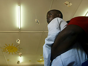 Un nio con sida en brazos de una enfermera en una clnica de Kampala. (AFP)