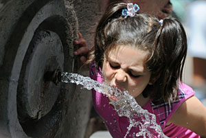 Una niña bebe de una fuente en Roma. (Foto: Tiziana Fabi | AFP)
