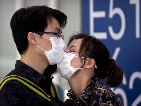 Una pareja se besa en China al inicio de la pandemia. | AP