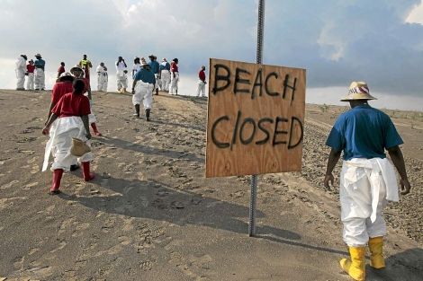 Voluntarios en tareas de limpieza en una playa del golfo. | Jae C. Hong