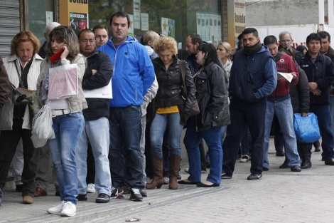 Decenas de personas hacen cola para entrar en una Oficina de Empleo de Madrid. | Reuters