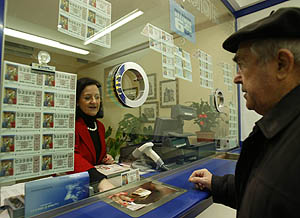 Un hombre compra un dcimo de lotera de Navidad, en una administracin de Vitoria. (Foto: A.R.)